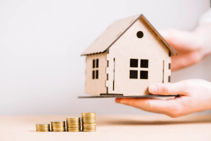 crop-hand-holding-house-near-coins_23-2147797665 crop hand holding house near coins 23 2147797665