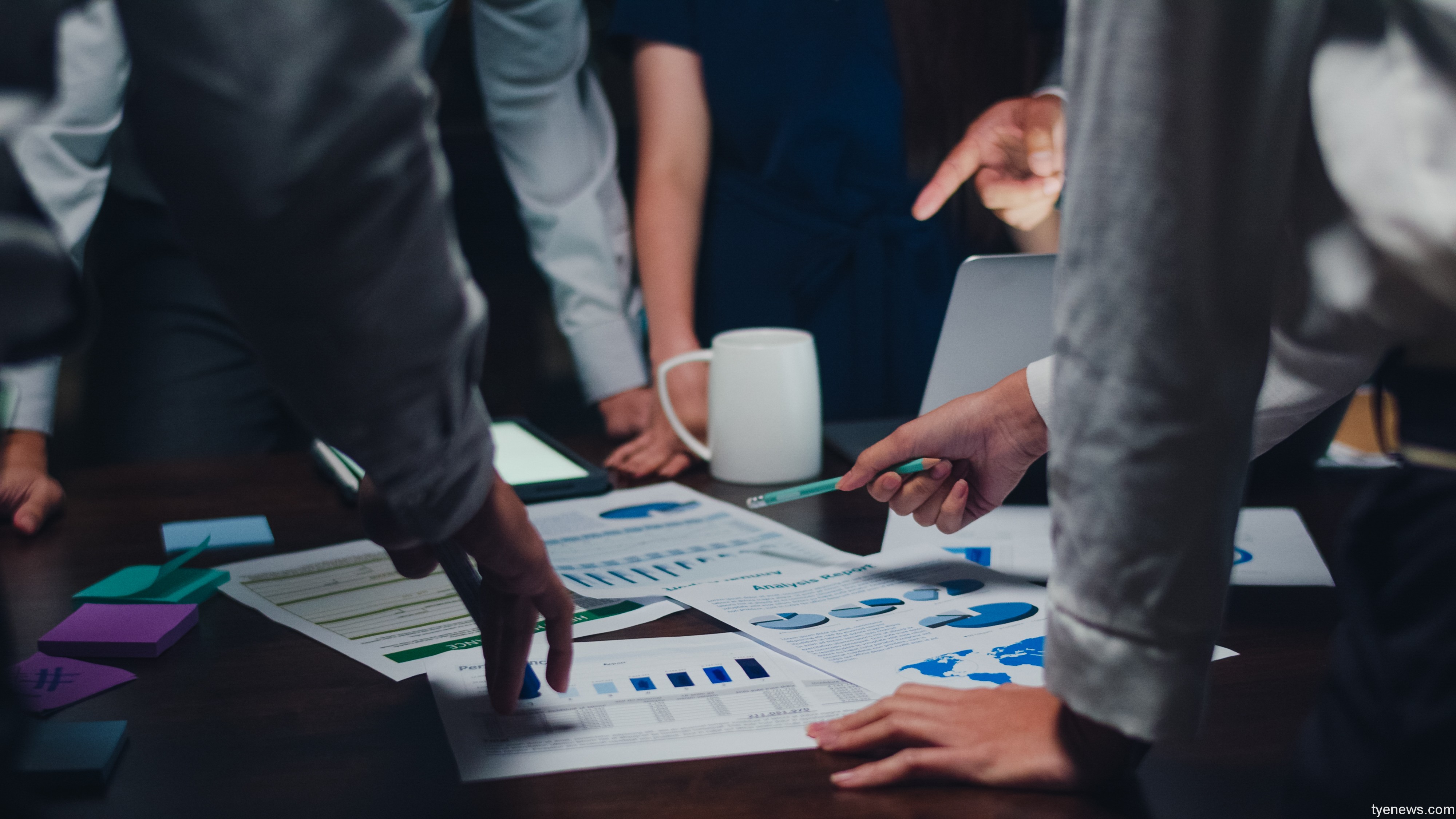 millennial asia businessmen businesswomen meeting brainstorming ideas about new paperwork project colleagues working together planning success strategy enjoy teamwork small modern night office
