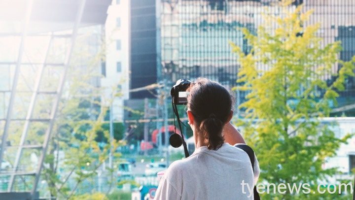 tourist traveller standing taking photo tower osaka japan near station around
