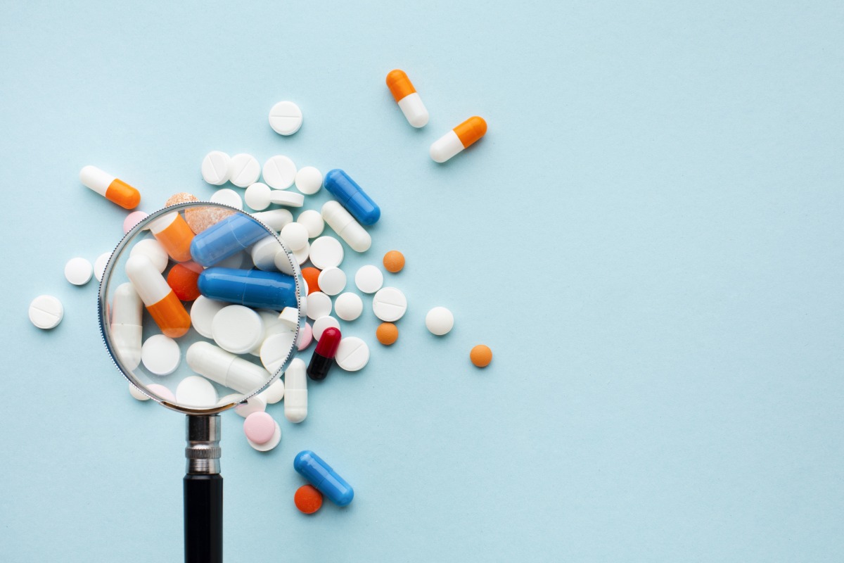 magnifying glass colourful pills
