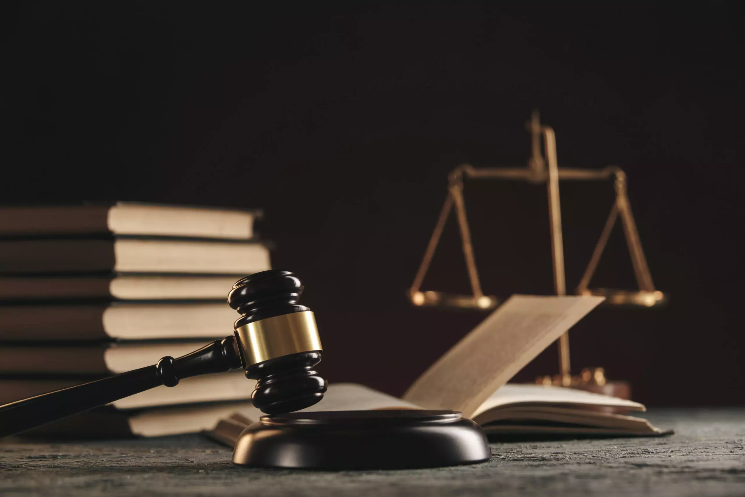 law concept open law book with wooden judges gavel table courtroom law enforcement office black background scaled