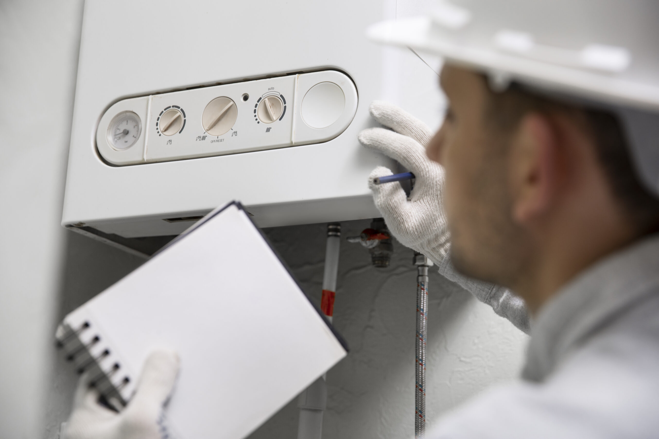 worker repairing water heater scaled