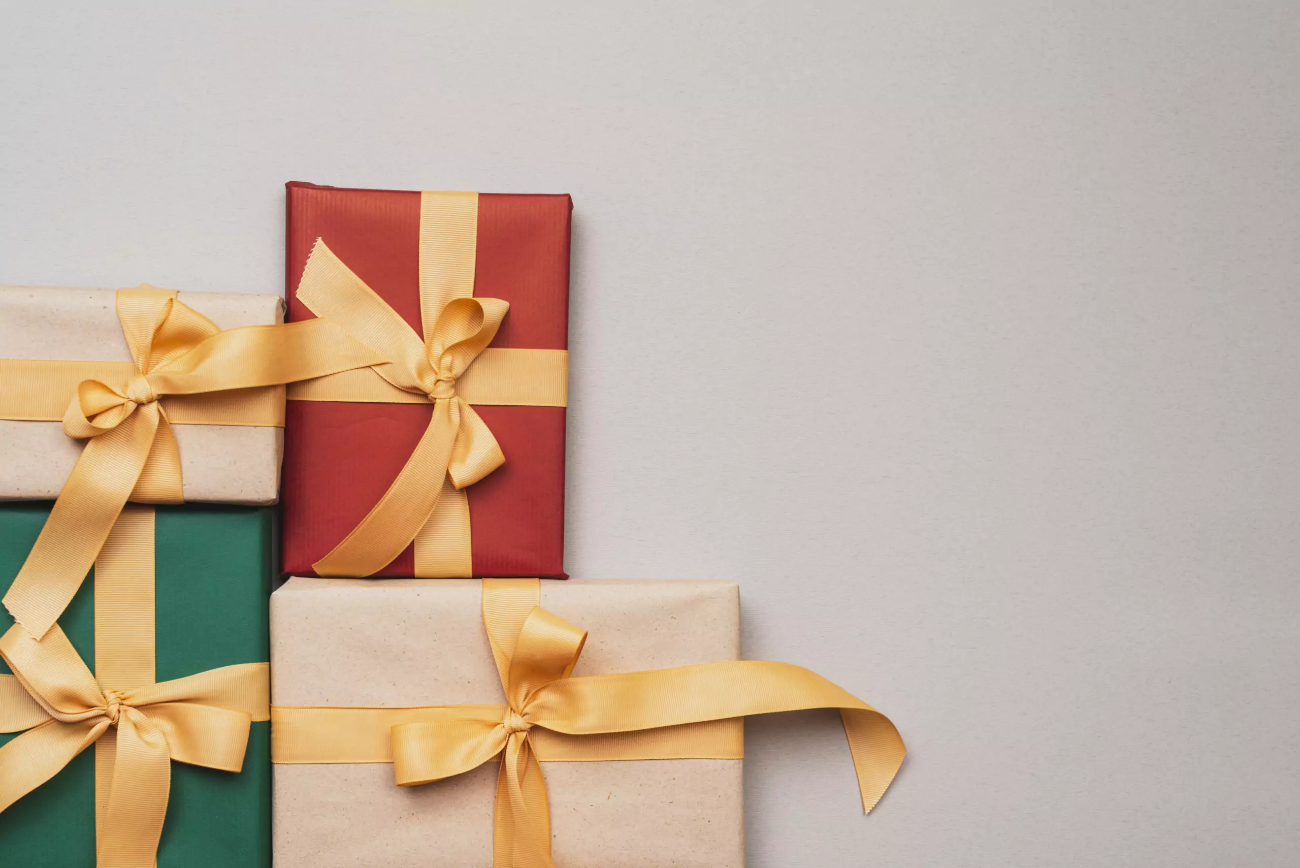 collection christmas presents with golden ribbon scaled