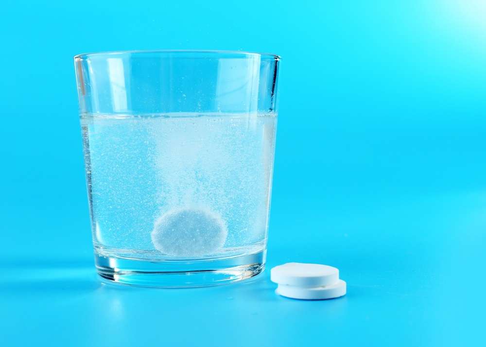 glass water pills blue background