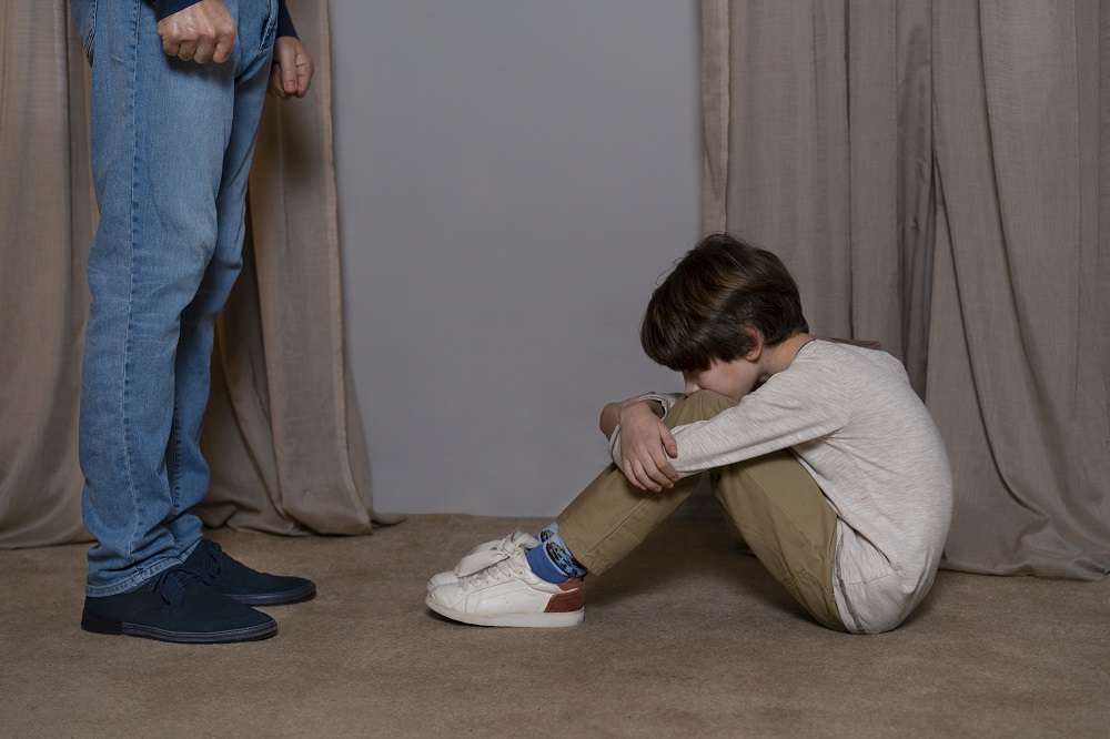 young child suffering from abuse by parent home