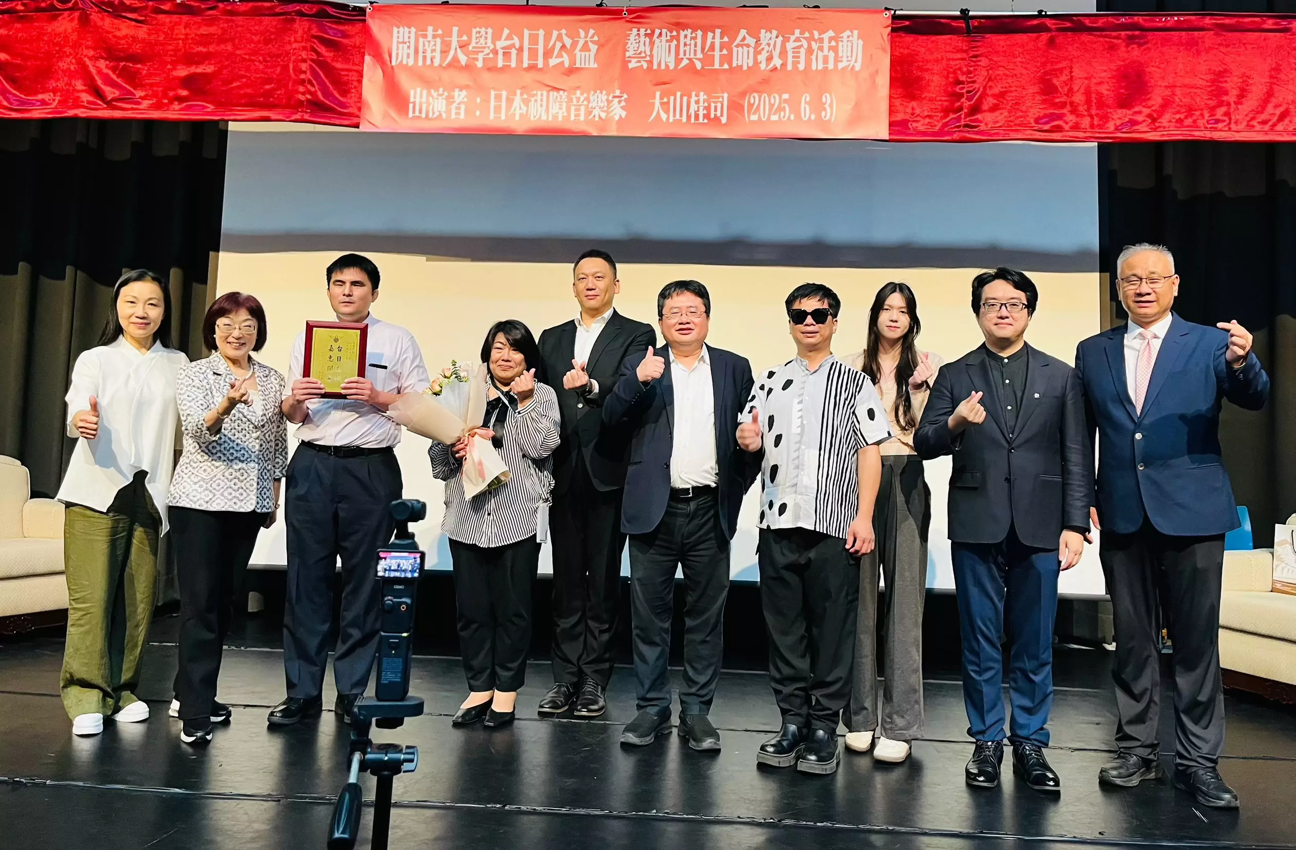 開南大學顏志光董事長（左5）與周守民校長（左2）與對話歌手和來賓合影