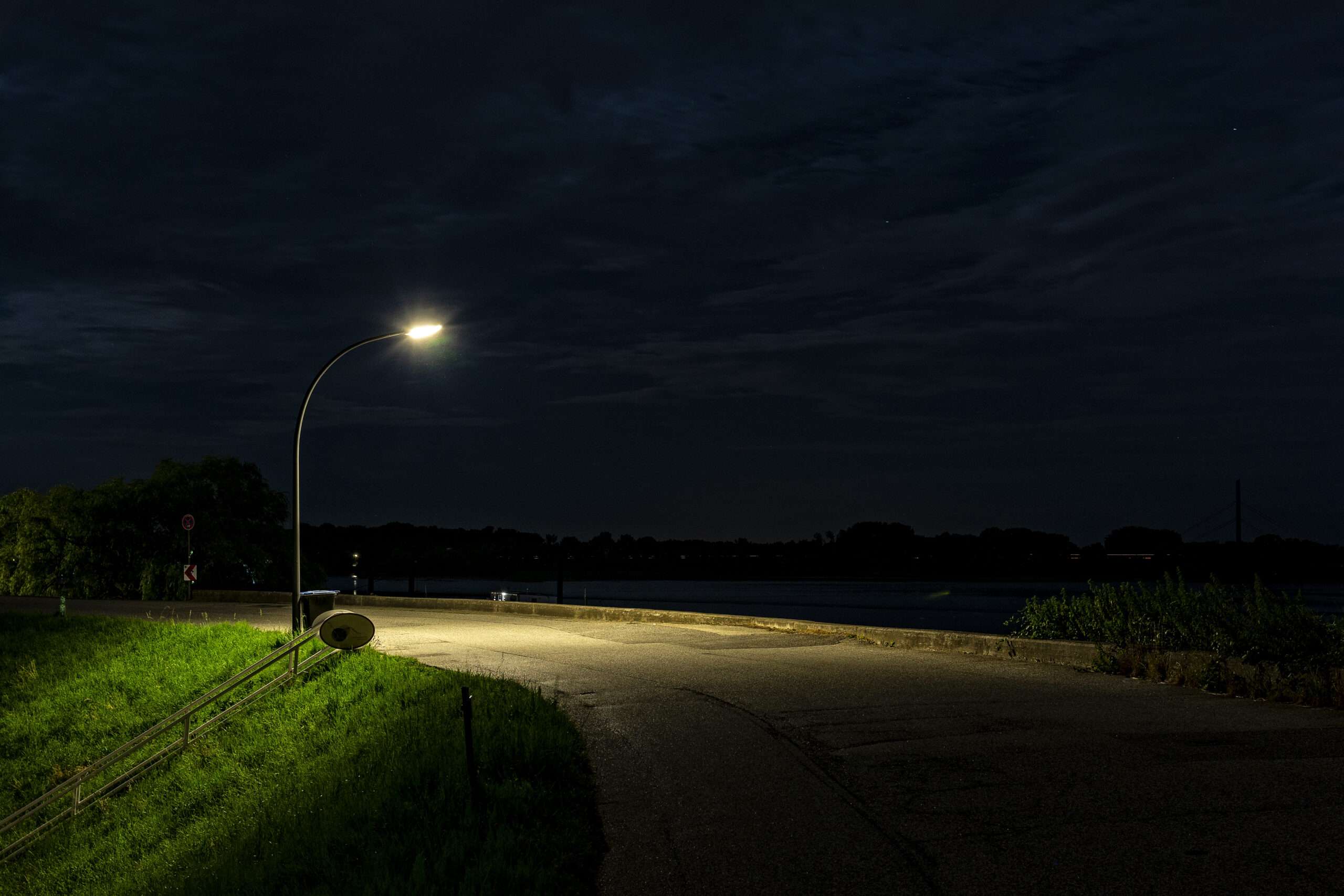 illuminated street light by road night scaled
