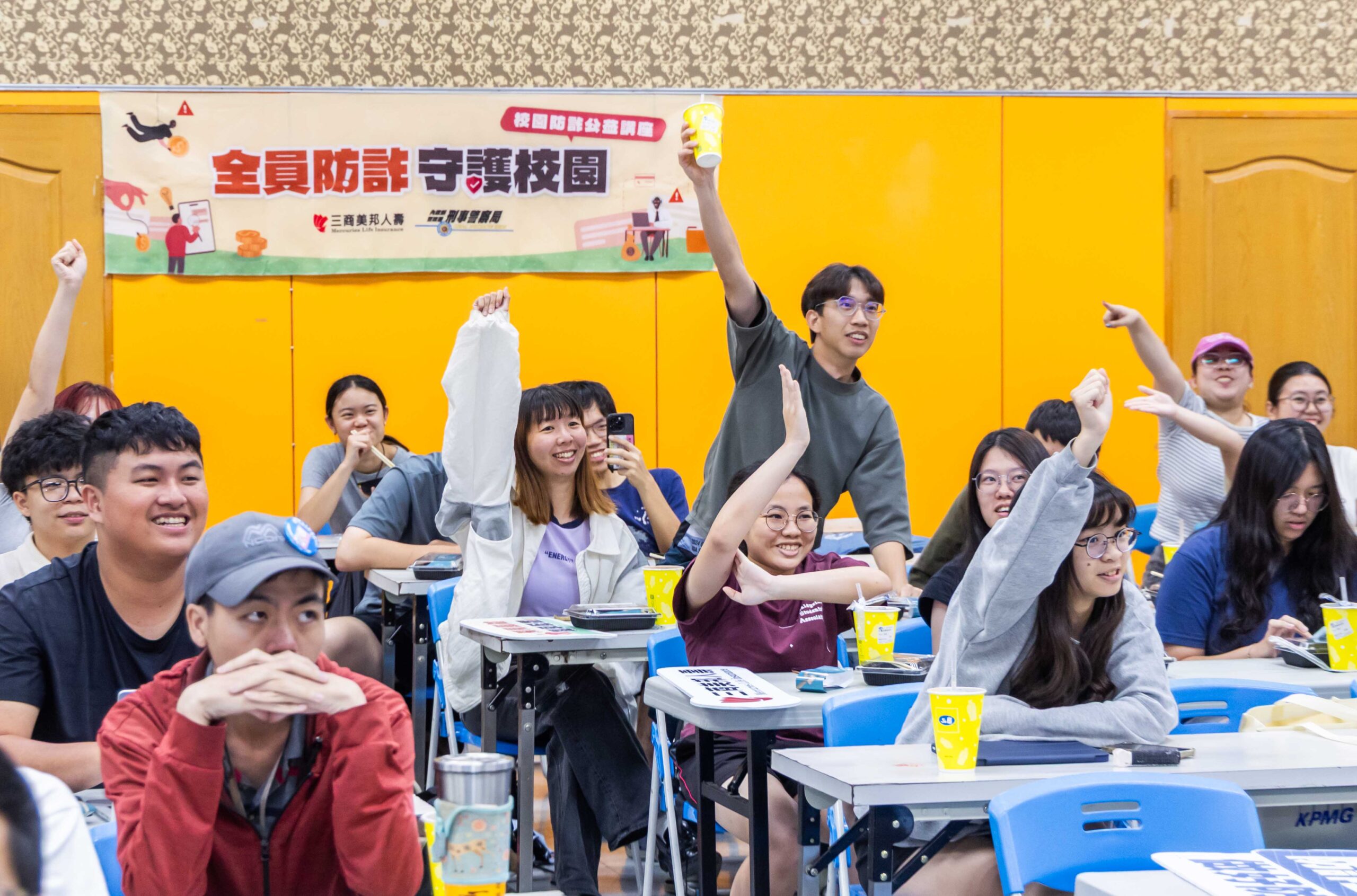 圖三：臺灣師範大學學生踴躍舉手參與有獎徵答互動環節，在輕鬆熱絡的氛圍中加深對防詐觀念與風險意識的理解。 scaled
